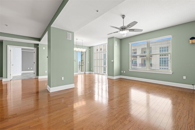 1227 E Madison St Unit 902, Tampa, FL 33602 - unfurnished living room featuring a ceiling fan, wood finished floors, and baseboards