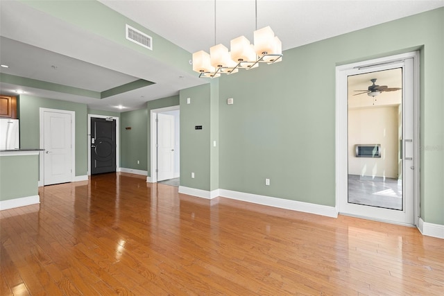 1227 E Madison St Unit 902, Tampa, FL 33602 - spare room with light wood-type flooring, baseboards, a chandelier, and ceiling fan