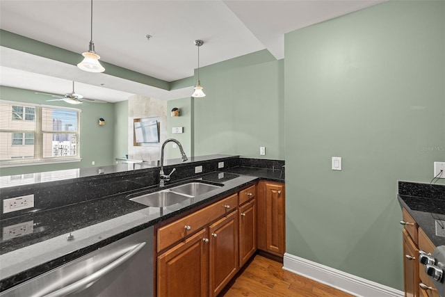 1227 E Madison St Unit 902, Tampa, FL 33602 - kitchen featuring stainless steel dishwasher, a sink, light wood-type flooring, pendant lighting, and brown cabinets