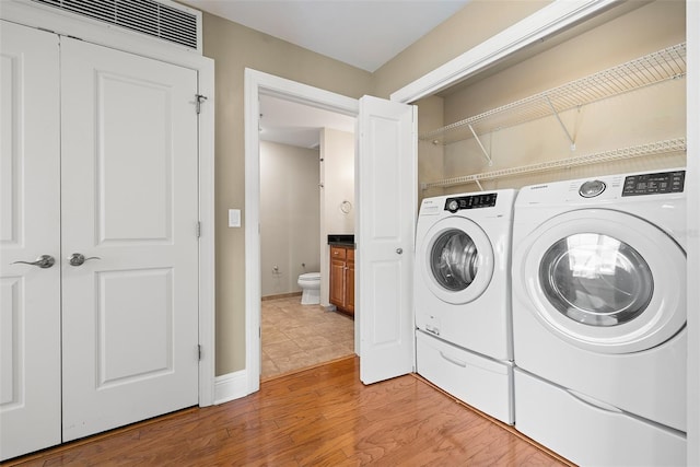 1227 E Madison St Unit 902, Tampa, FL 33602 - washroom featuring washer and dryer and light wood finished floors