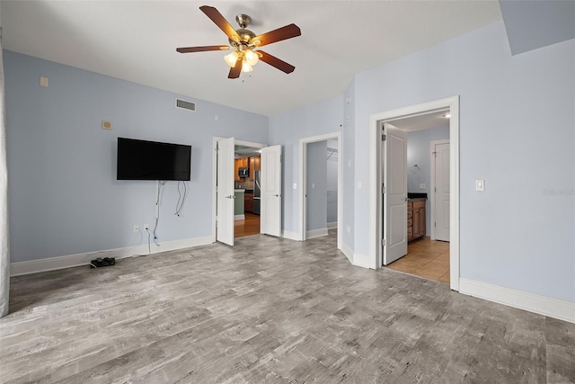1227 E Madison St Unit 902, Tampa, FL 33602 - unfurnished living room with ceiling fan, light wood-type flooring, and baseboards