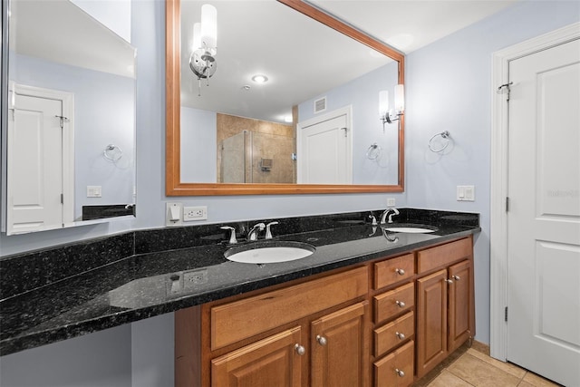 1227 E Madison St Unit 902, Tampa, FL 33602 - bathroom with a shower stall, double vanity, and tile patterned flooring