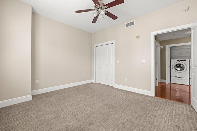 1227 E Madison St Unit 902, Tampa, FL 33602 - unfurnished bedroom featuring washer / dryer, carpet floors, a closet, and baseboards