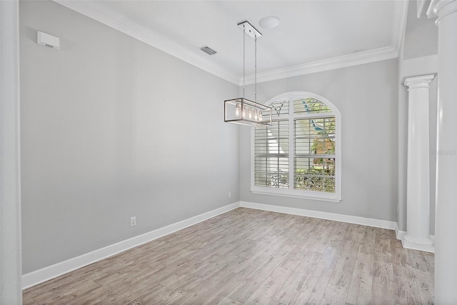 7314 Hunt Club Ln, Seminole, FL 33776 - unfurnished dining area featuring crown molding, wood finished floors, baseboards, and decorative columns