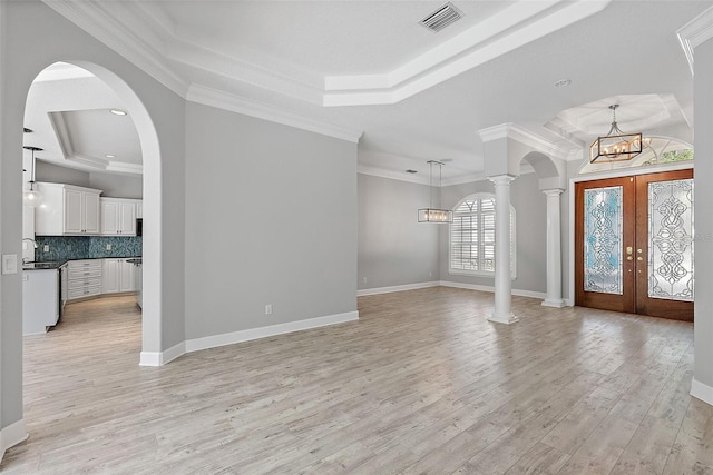 7314 Hunt Club Ln, Seminole, FL 33776 - foyer entrance featuring a raised ceiling, a chandelier, light wood-type flooring, crown molding, and baseboards