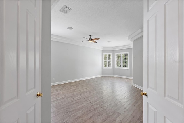 7314 Hunt Club Ln, Seminole, FL 33776 - unfurnished room with ceiling fan, crown molding, wood finished floors, baseboards, and a textured ceiling