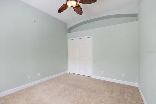 7314 Hunt Club Ln, Seminole, FL 33776 - unfurnished bedroom featuring carpet, a closet, baseboards, vaulted ceiling, and a ceiling fan