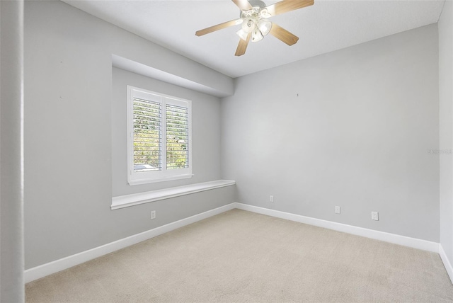 7314 Hunt Club Ln, Seminole, FL 33776 - spare room featuring light colored carpet, baseboards, and a ceiling fan