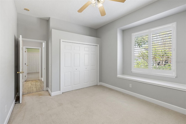 7314 Hunt Club Ln, Seminole, FL 33776 - unfurnished bedroom featuring carpet floors, a closet, baseboards, and a ceiling fan