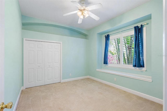 7314 Hunt Club Ln, Seminole, FL 33776 - unfurnished bedroom with carpet, a closet, baseboards, and ceiling fan