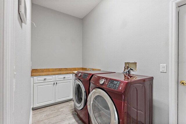 7314 Hunt Club Ln, Seminole, FL 33776 - clothes washing area with washer and dryer, light wood finished floors, and cabinet space