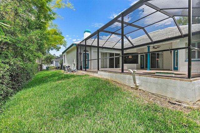 7314 Hunt Club Ln, Seminole, FL 33776 - back of property featuring ceiling fan, a chimney, a patio, a yard, and a lanai