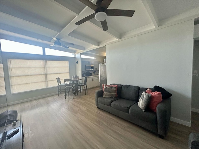 living room with beam ceiling, a ceiling fan, baseboards, wood finished floors, and coffered ceiling
