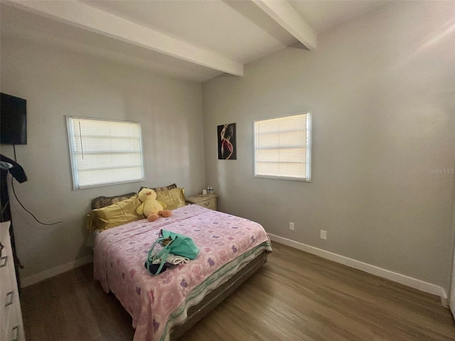 bedroom with wood finished floors, baseboards, and beam ceiling