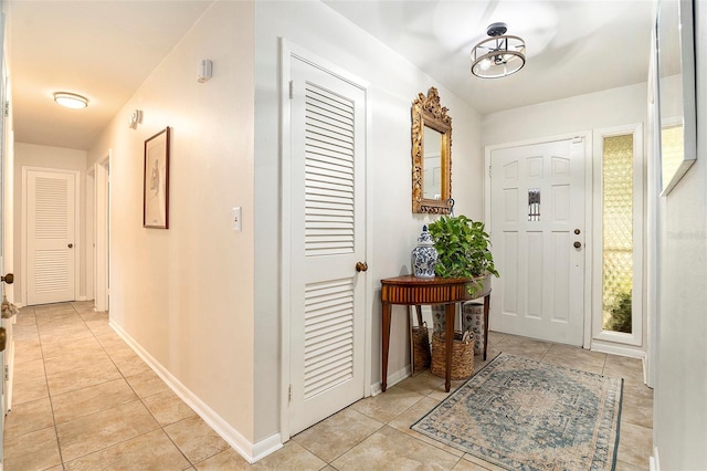 entryway featuring light tile patterned floors and baseboards