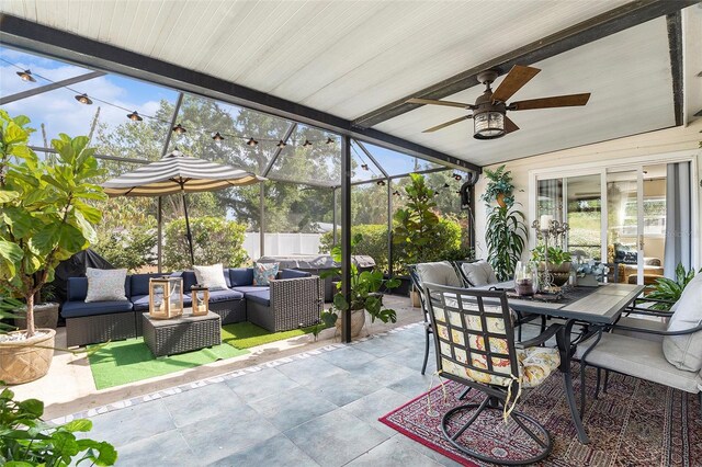 sunroom / solarium featuring outdoor lounge area, a ceiling fan, outdoor dining area, and vaulted ceiling