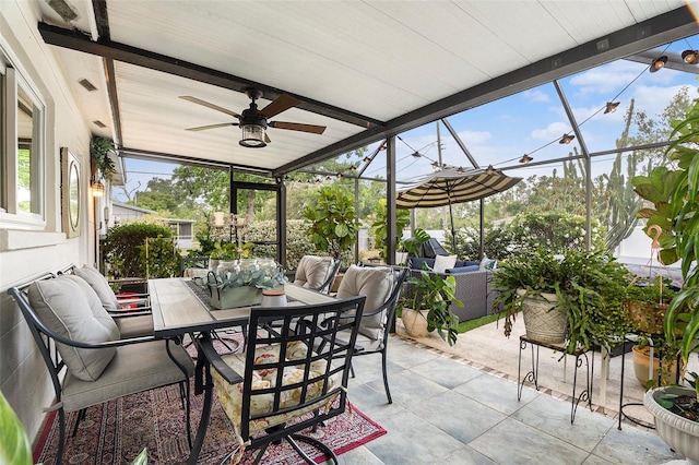 sunroom featuring ceiling fan, outdoor lounge area, and outdoor dining space