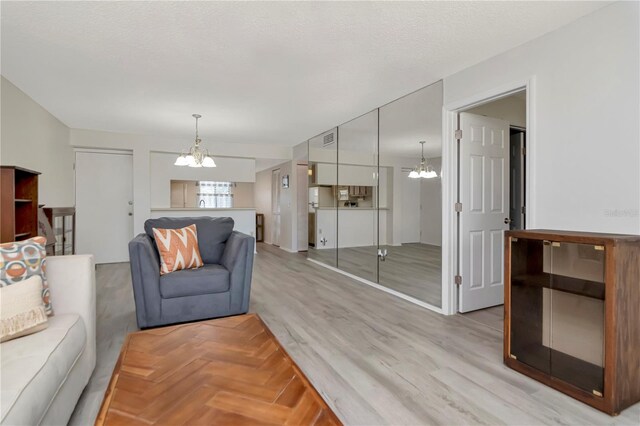 112 W Cypress Ct, Oldsmar, FL 34677 - living area with parquet flooring, a chandelier, and visible vents