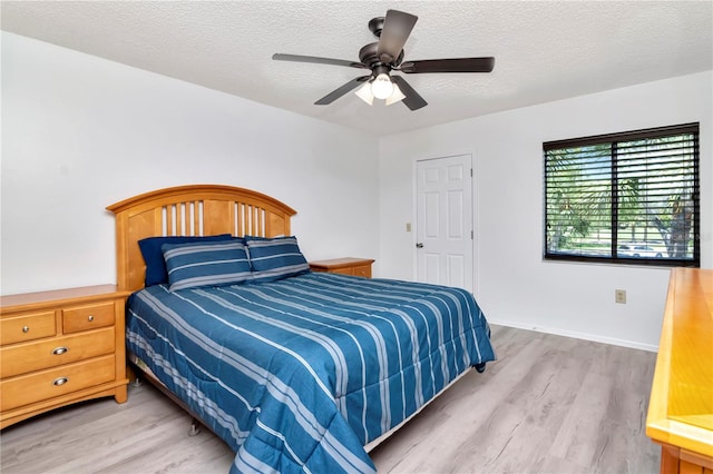 112 W Cypress Ct, Oldsmar, FL 34677 - bedroom with a textured ceiling, baseboards, a ceiling fan, and wood finished floors
