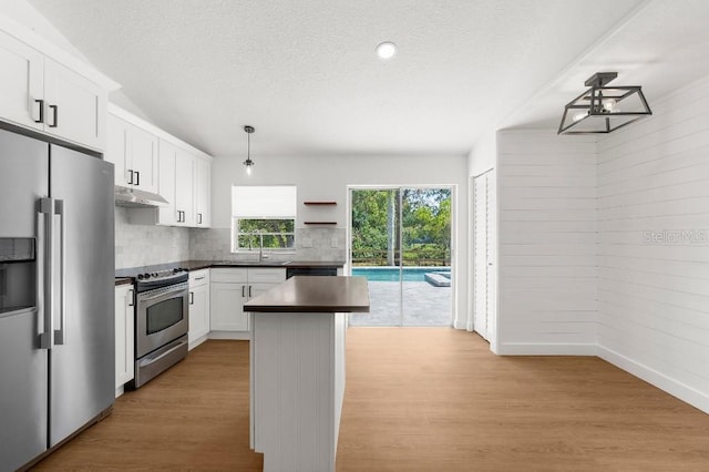 kitchen with dark countertops, open shelves, stainless steel appliances, backsplash, and under cabinet range hood