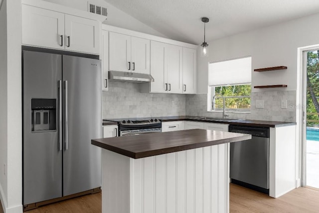kitchen featuring wooden counters, visible vents, a sink, under cabinet range hood, and stainless steel appliances