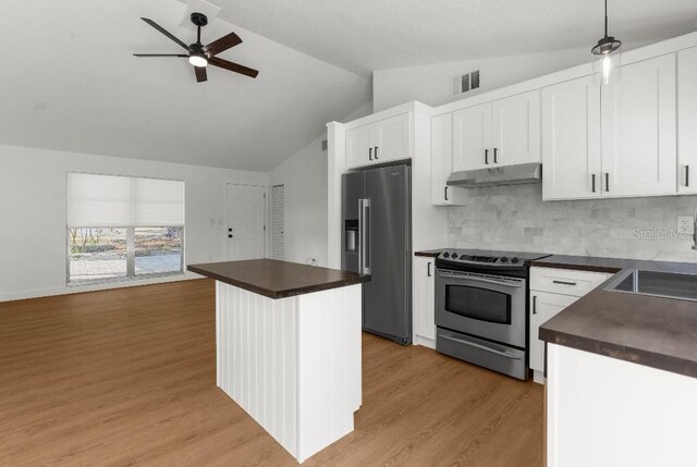 kitchen with visible vents, lofted ceiling, under cabinet range hood, a ceiling fan, and appliances with stainless steel finishes