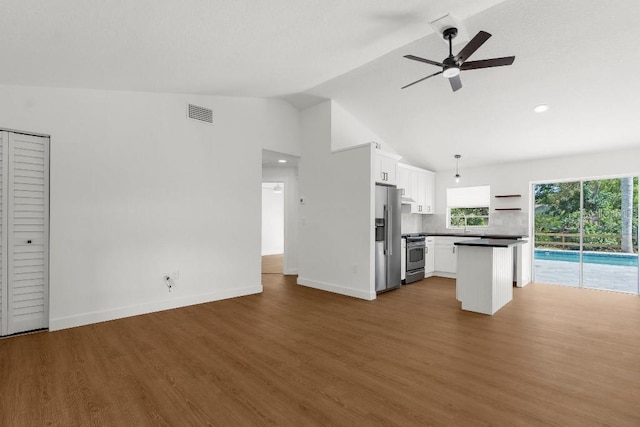 kitchen with open floor plan, white cabinetry, ceiling fan, and stainless steel appliances