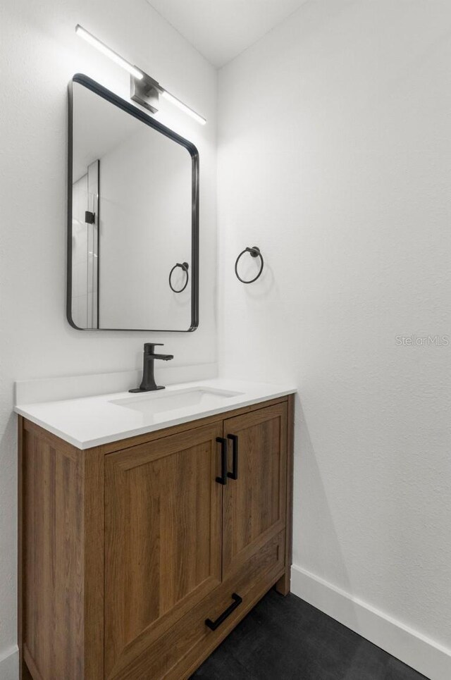 bathroom featuring baseboards and vanity