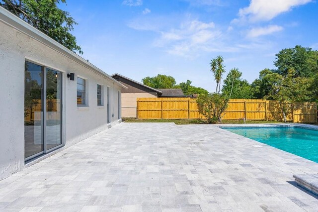 view of pool with a fenced backyard, a fenced in pool, and a patio area