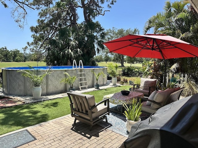 view of patio / terrace with an outdoor pool and an outdoor hangout area