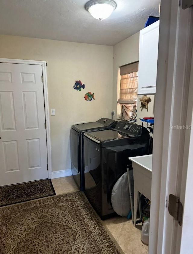 laundry area featuring laundry area, light tile patterned flooring, and washer and dryer