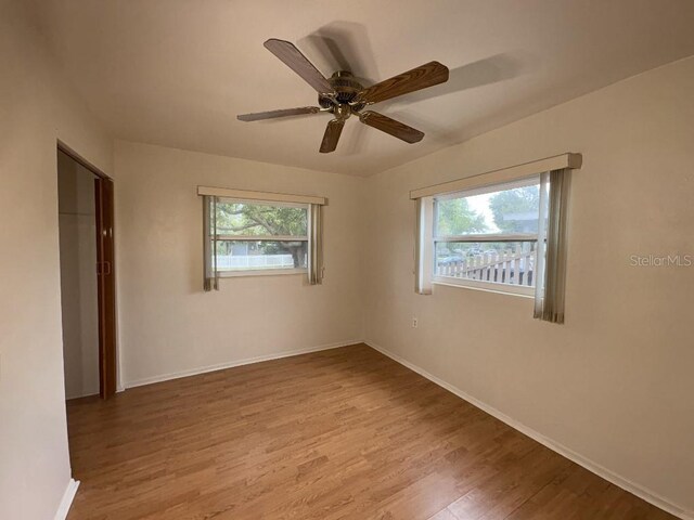 interior space featuring baseboards, a healthy amount of sunlight, and wood finished floors