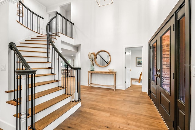 101 Ponce De Leon Blvd, Belleair, FL 33756 - foyer entrance featuring baseboards, stairs, a high ceiling, and wood finished floors