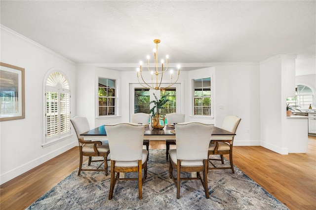 101 Ponce De Leon Blvd, Belleair, FL 33756 - dining space featuring baseboards, ornamental molding, light wood finished floors, and a chandelier