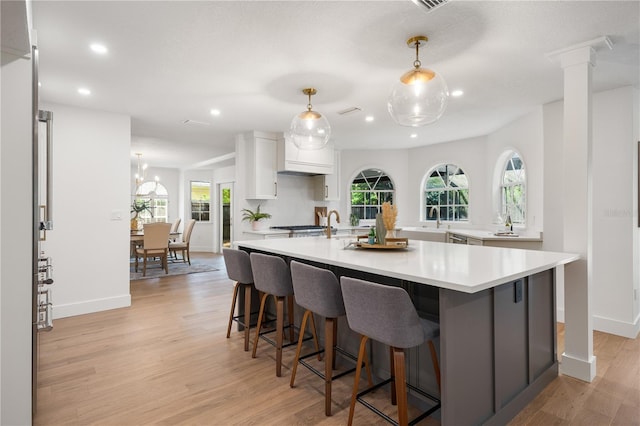 101 Ponce De Leon Blvd, Belleair, FL 33756 - kitchen featuring white cabinets, light countertops, light wood-style flooring, and recessed lighting