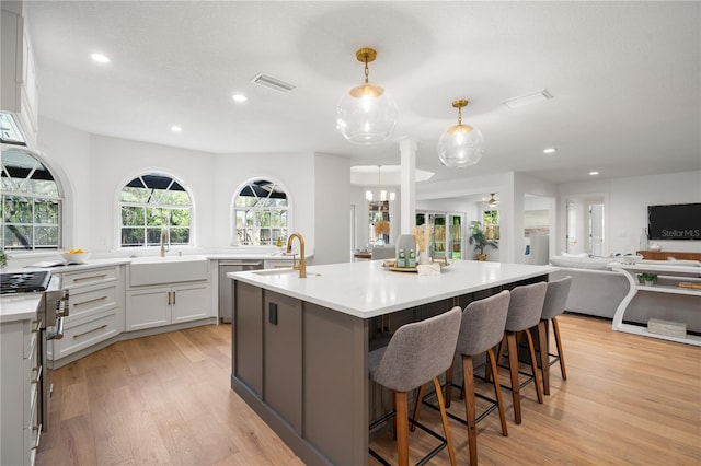 101 Ponce De Leon Blvd, Belleair, FL 33756 - kitchen with light wood-style floors, stainless steel appliances, open floor plan, and a sink