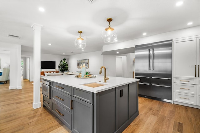 101 Ponce De Leon Blvd, Belleair, FL 33756 - kitchen featuring a sink, gray cabinets, visible vents, light countertops, and stainless steel built in fridge