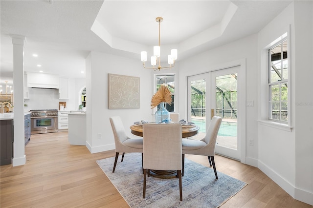 101 Ponce De Leon Blvd, Belleair, FL 33756 - dining room featuring a notable chandelier, light wood-style flooring, recessed lighting, baseboards, and a raised ceiling