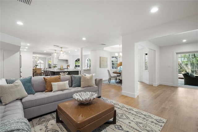 101 Ponce De Leon Blvd, Belleair, FL 33756 - living room featuring a notable chandelier, recessed lighting, baseboards, visible vents, and light wood-type flooring