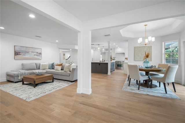 101 Ponce De Leon Blvd, Belleair, FL 33756 - living room with recessed lighting, baseboards, light wood finished floors, a chandelier, and a raised ceiling