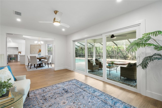 101 Ponce De Leon Blvd, Belleair, FL 33756 - doorway featuring ceiling fan with notable chandelier, wood finished floors, visible vents, recessed lighting, and a sunroom