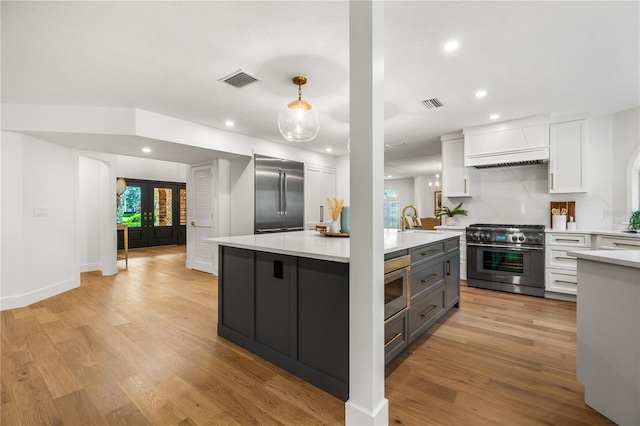 101 Ponce De Leon Blvd, Belleair, FL 33756 - kitchen with high end appliances, light countertops, white cabinets, and visible vents