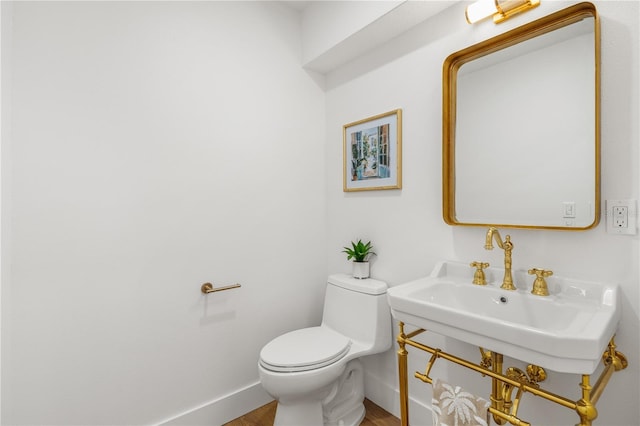 101 Ponce De Leon Blvd, Belleair, FL 33756 - bathroom with toilet, baseboards, and wood finished floors