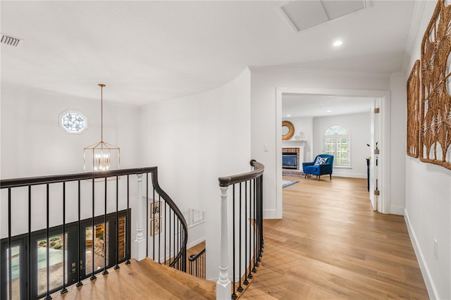 101 Ponce De Leon Blvd, Belleair, FL 33756 - hallway with an inviting chandelier, wood finished floors, an upstairs landing, visible vents, and recessed lighting