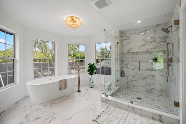 101 Ponce De Leon Blvd, Belleair, FL 33756 - bathroom with a freestanding bath, a marble finish shower, a healthy amount of sunlight, and visible vents
