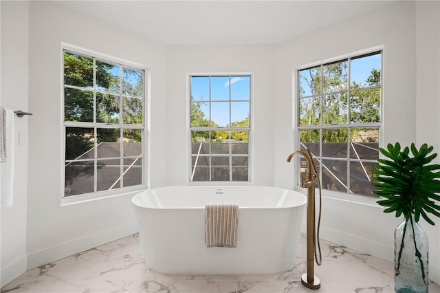 101 Ponce De Leon Blvd, Belleair, FL 33756 - full bathroom with baseboards, marble finish floor, and a freestanding tub