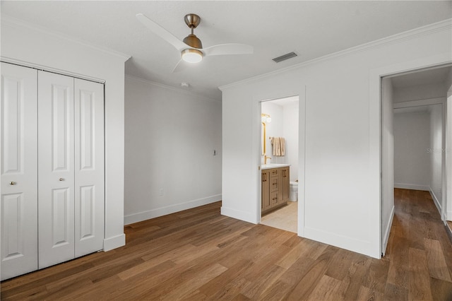 101 Ponce De Leon Blvd, Belleair, FL 33756 - unfurnished bedroom featuring baseboards, ornamental molding, light wood finished floors, and a closet