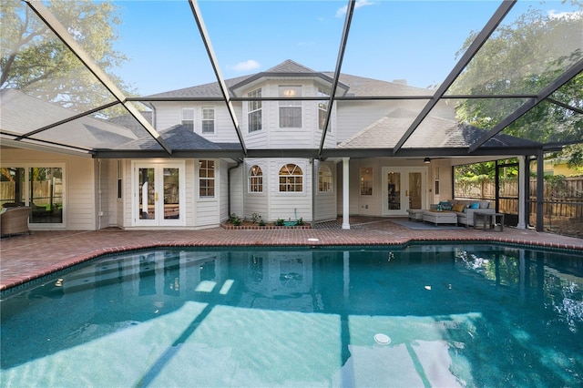 101 Ponce De Leon Blvd, Belleair, FL 33756 - back of house with french doors, outdoor lounge area, an outdoor pool, a patio area, and glass enclosure