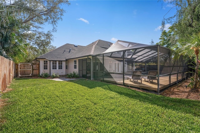 101 Ponce De Leon Blvd, Belleair, FL 33756 - rear view of house with roof with shingles, a wooden deck, a lawn, and a fenced backyard