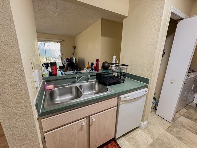 3705 SW 27th St Unit 214, Gainesville, FL 32608 - kitchen with white dishwasher, a sink, a textured wall, a textured ceiling, and dark countertops